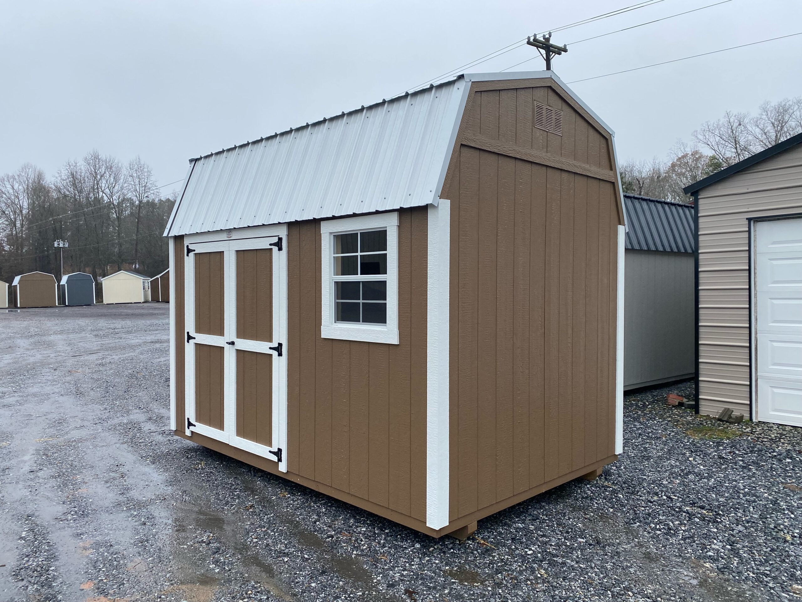 Brown 10x12 DUTCHBARN shed with white trim and metal roof for sale in SC