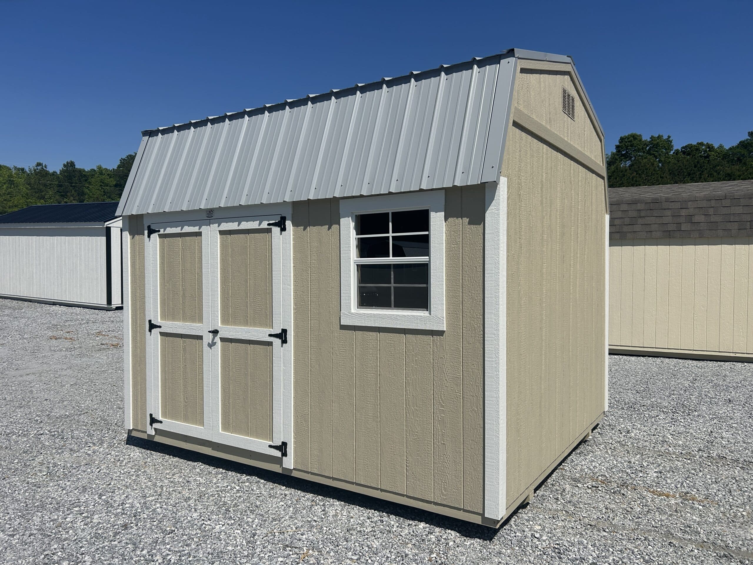 Tan 10x12 Dutchbarn shed with white trim and grey metal roof for sale in SC