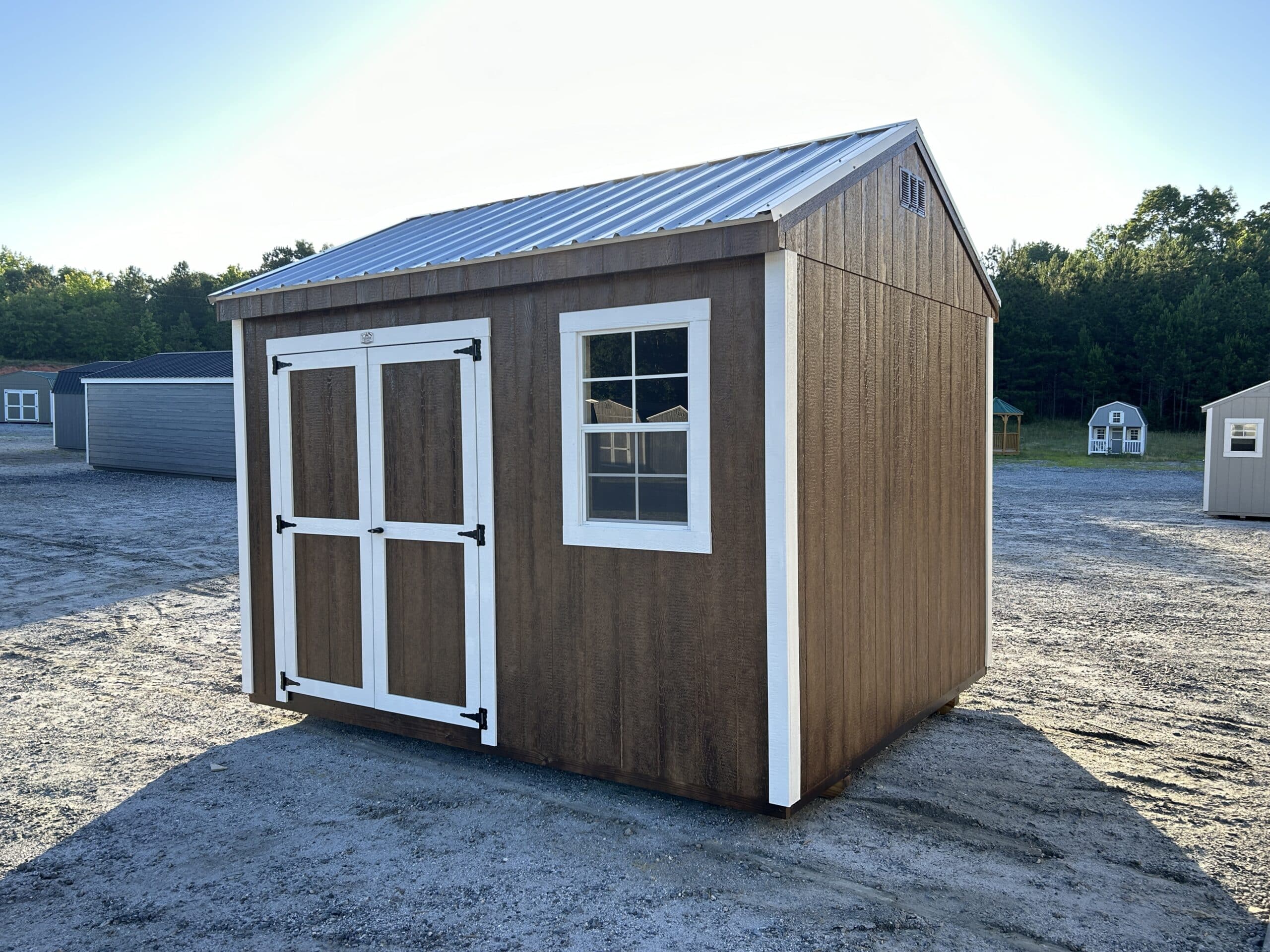 brown 10x12 workshop shed with white trim and silver metal roof for sale in SC
