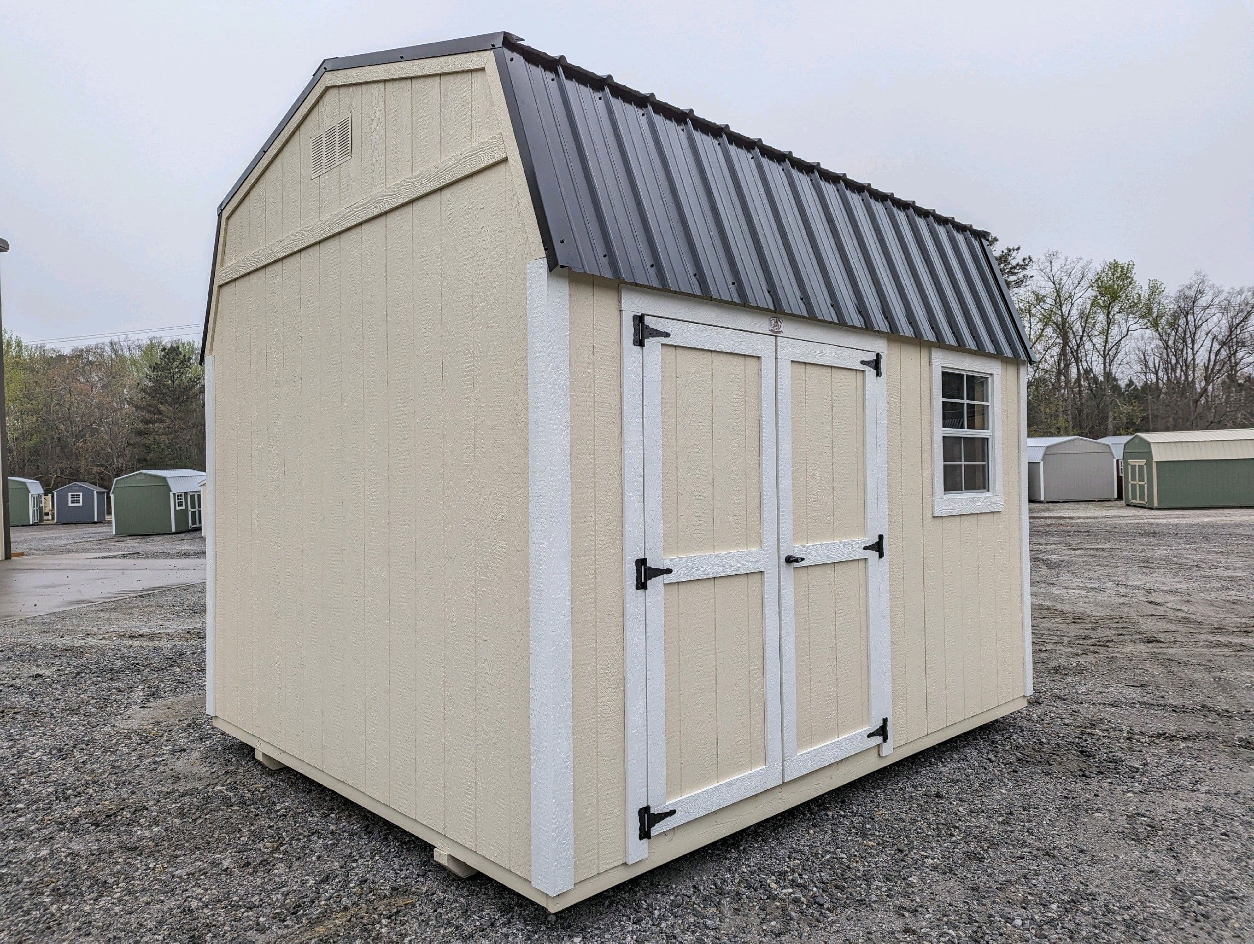 cream 10x12 DUTCHBARN with white trim and dark grey metal roof for sale in SC