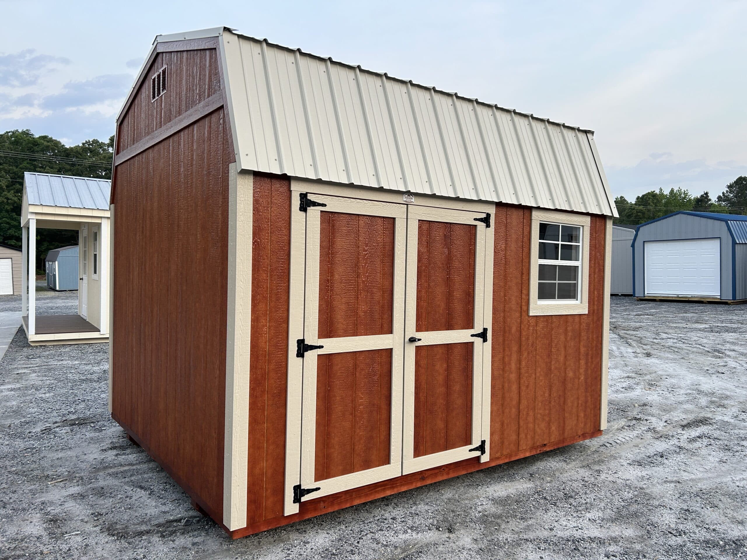 red 10x12 Dutchbarn with cream trim and cream collered metal roof for sale in SC