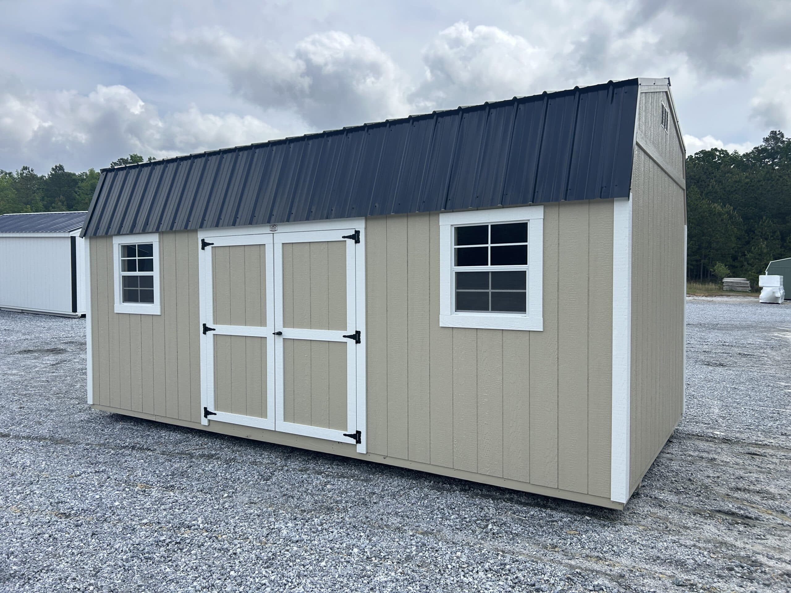 10x20 beige dutchbarn with white trim and dark blue metal roofing in SC