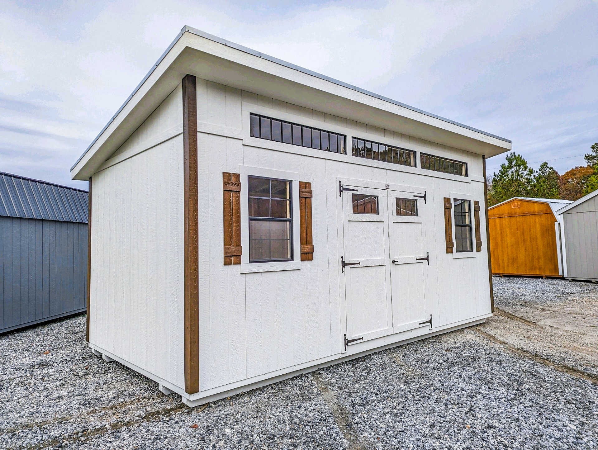 White carolina workshop shed with wood shutters shed in SC