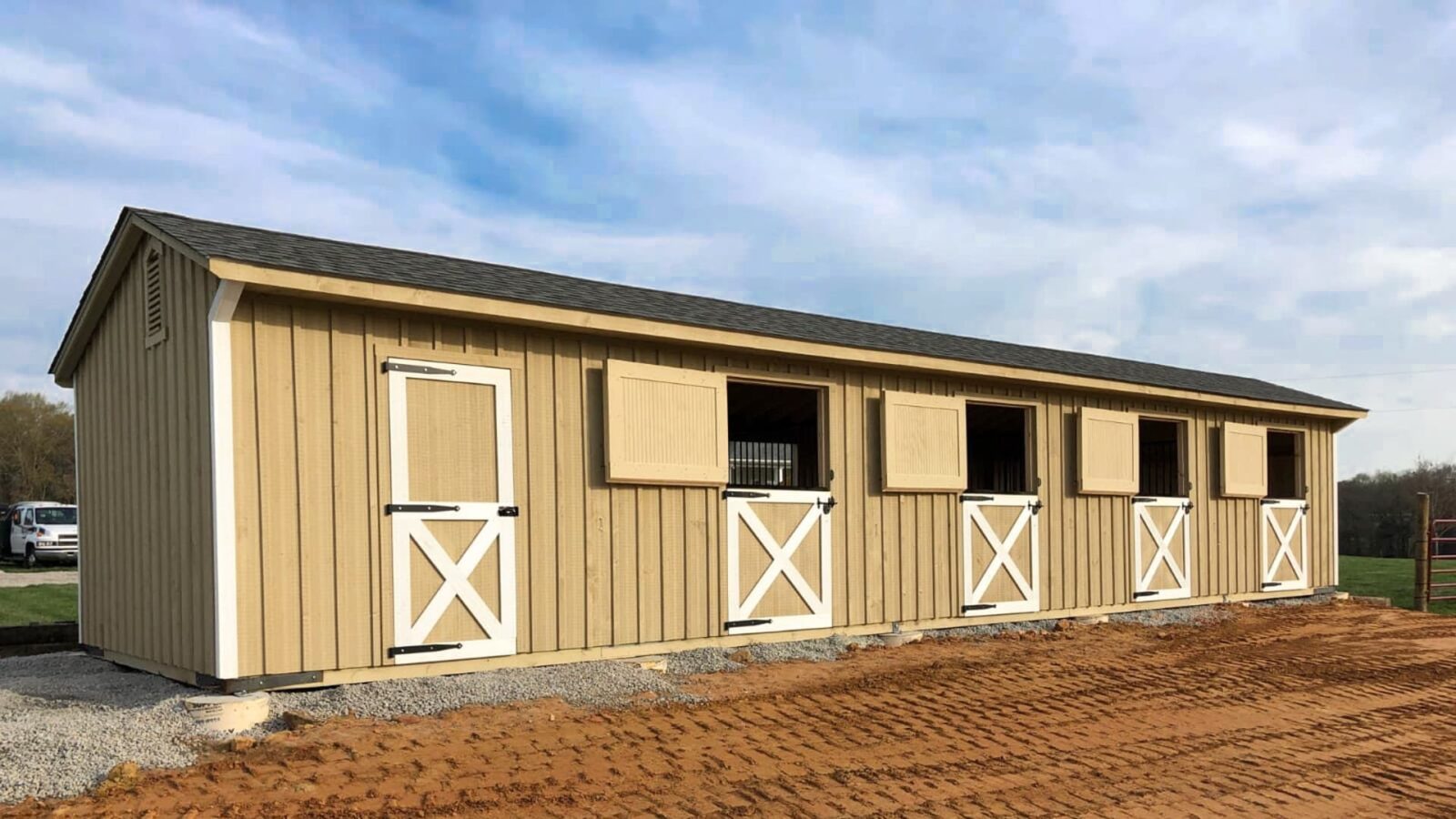 exterior of brown and white shed row barn for sale