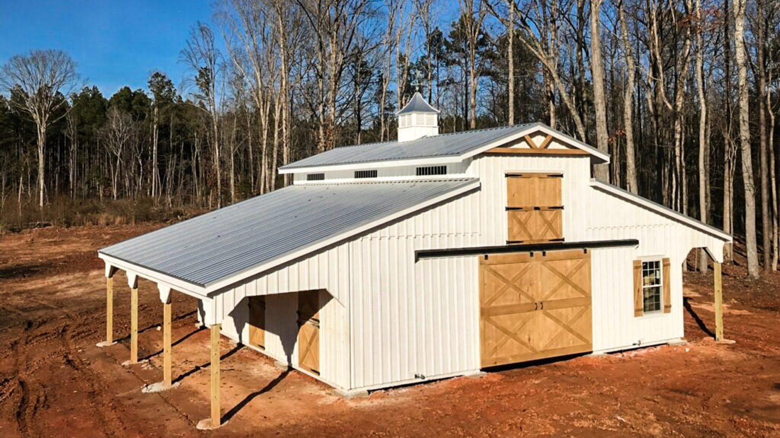 exterior of white and brown modular horse barn for sale in SC