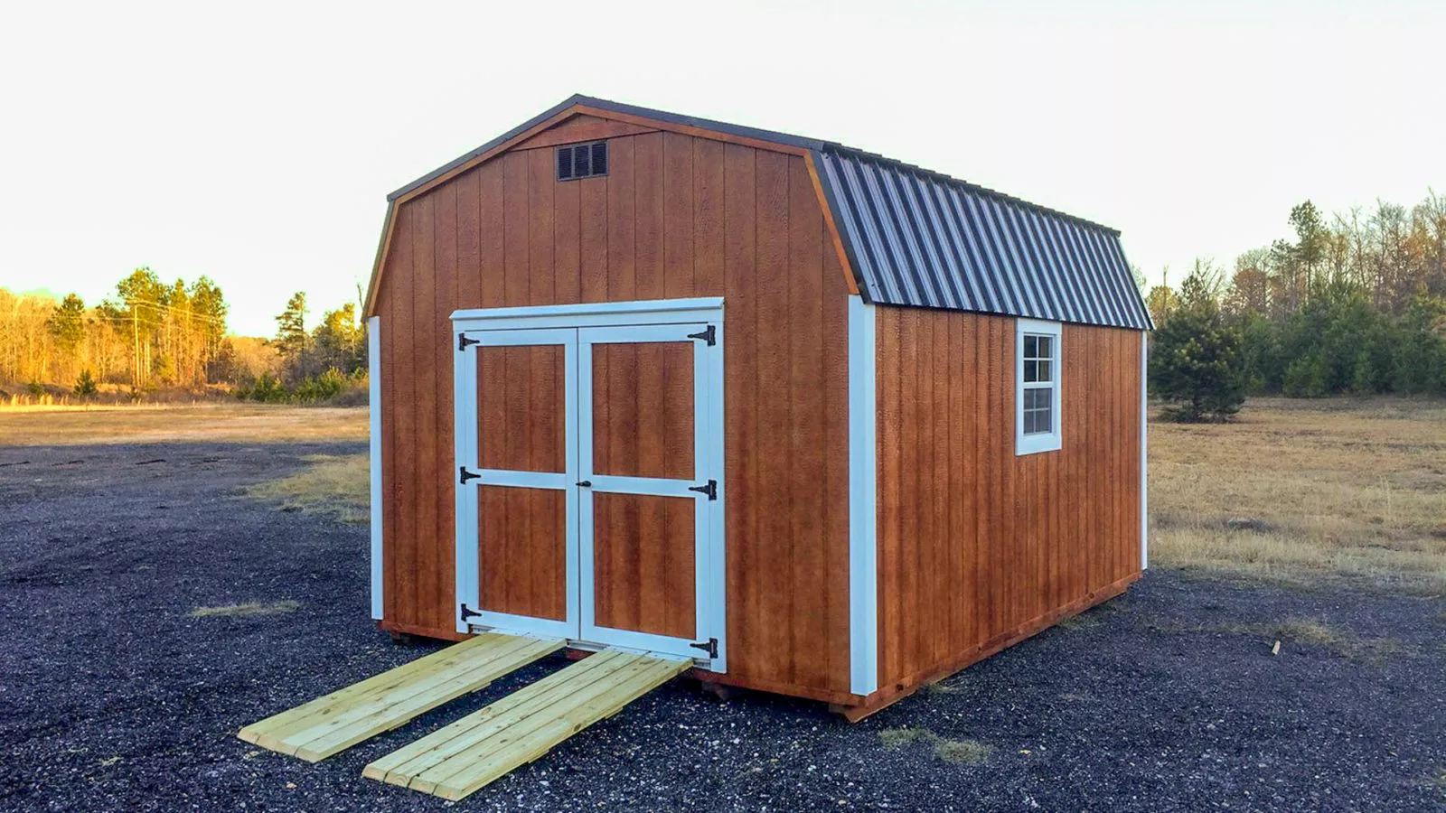 exterior of brown and white dutch barn pre-built storage shed for sale