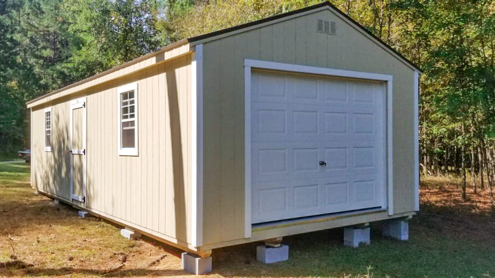 exterior of a white-doored pre-manufactured garage for sale