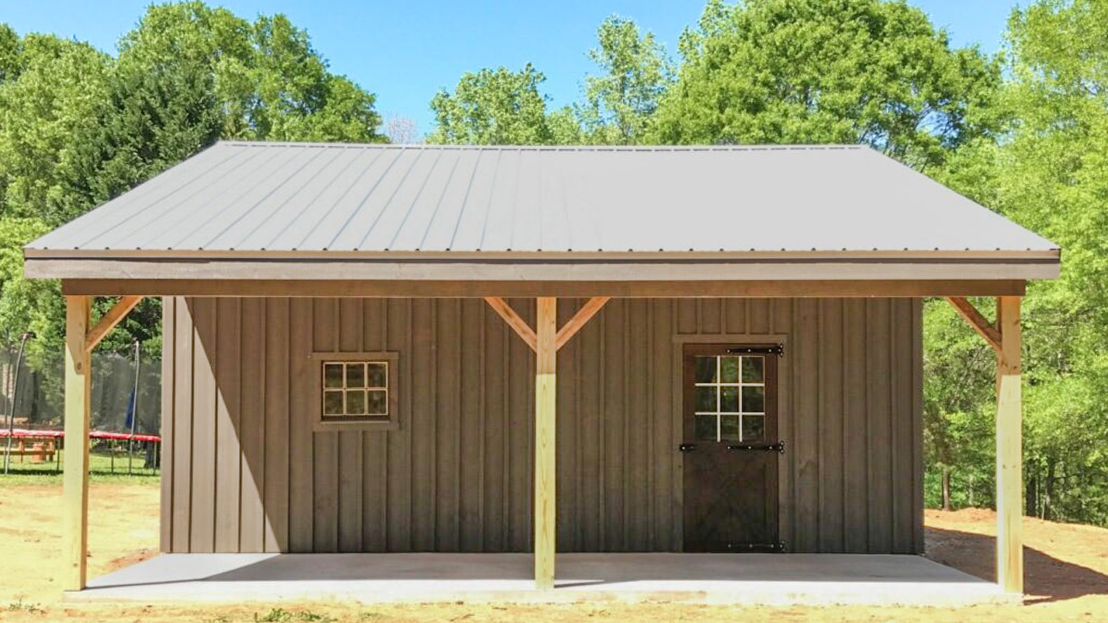 exterior of horse lean-to shed with concrete walkway