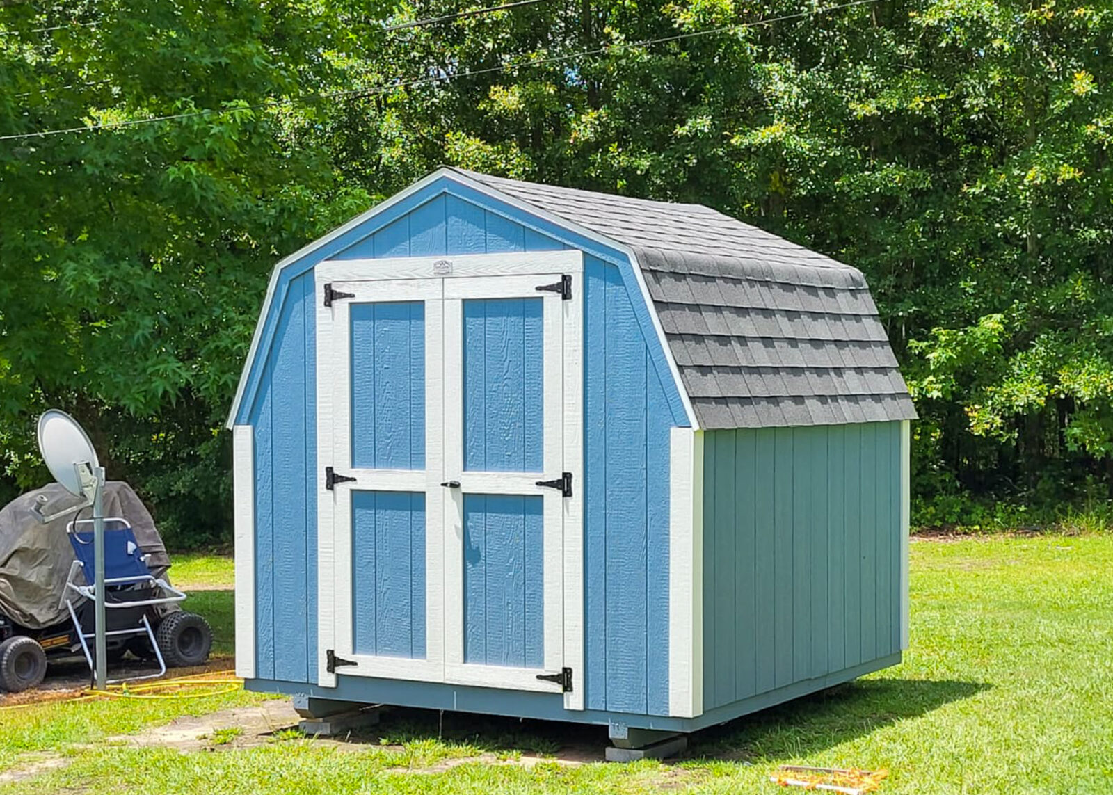 exterior of a blue minibarn rent to own sheds for sale